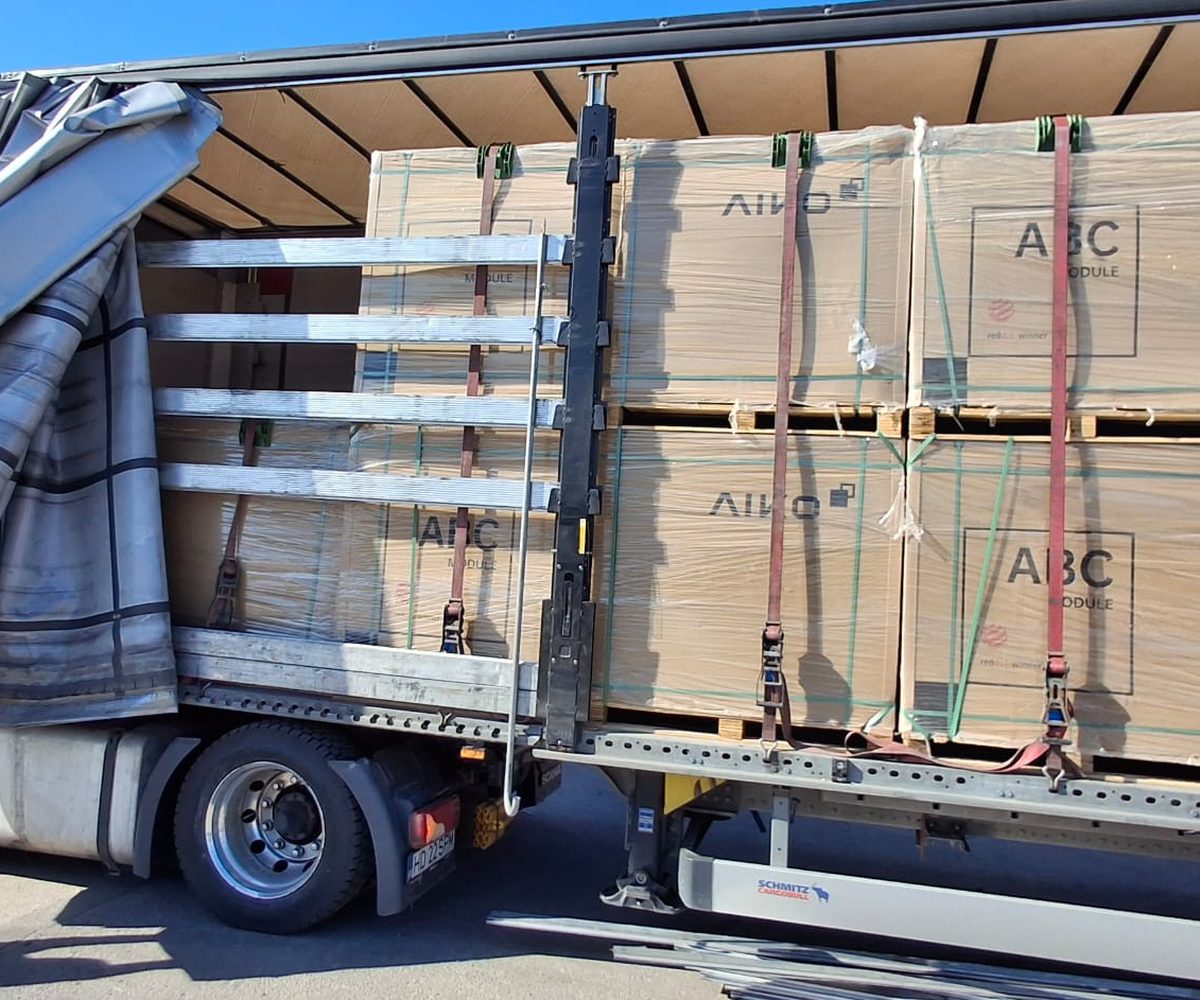 Truck with pallets of AIKO ABC panels being unloaded at the Nectaria warehouse in Alba Iulia